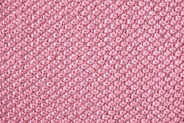 Knitted texture in pink color. Close up.