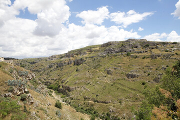 Fototapeta premium Simple suspension bridge on the canyon carved by the Gravina River where lies Matera, Basilicata, Italy