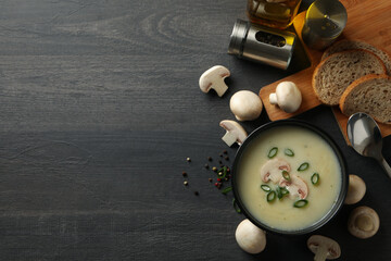 Concept of tasty lunch with bowl of mushroom soup on wooden background