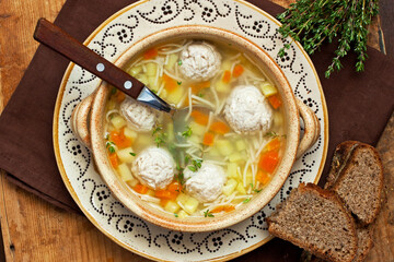 Soup with chicken meatballs and noodles, top view