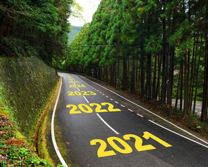 Ten year from 2021 to 2030 on highway road and white marking lines in the forest, Happy new year...