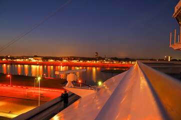 Large modern cruiseship or cruise ship liner passes or transits Ijmuiden locks during twilight...
