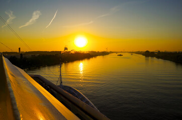 Modern cruiseship or cruise ship liner passes or transits North Sea Canal from Ijmuiden locks...