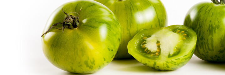 Food banner concept, organic vegetables and ingredients: close up of organic green tomatoes