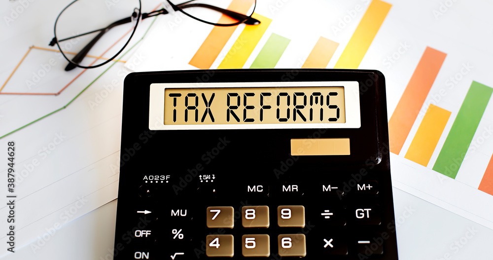 Poster calculator with the word tax reforms on the display with chart and glasses