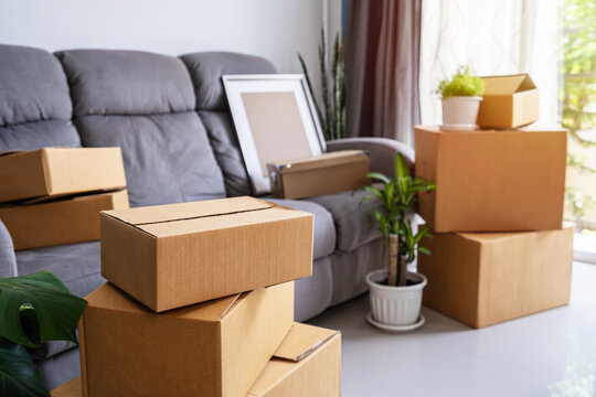 Stack of cardboard boxes in living room at new house on moving day