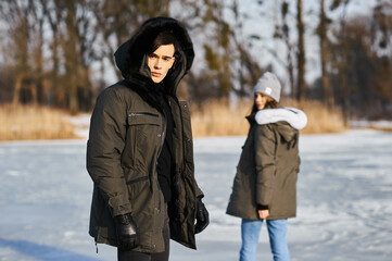 happy couple hugging and laughing outdoors in winter