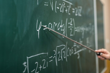 Mathematical formulas are written on the blackboard