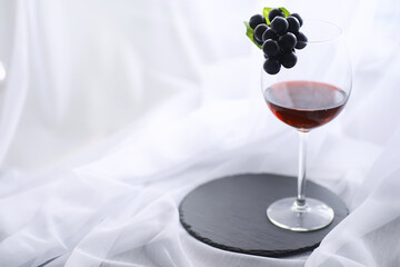 Glass with grape red semi-dry wine. Valentine's day concept background. Gift for the holiday. Sweet...