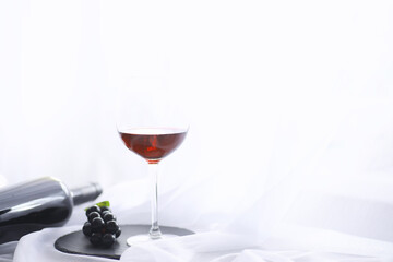 Glass with grape red semi-dry wine. Valentine's day concept background. Gift for the holiday. Sweet sparkling wine.