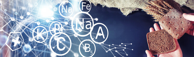 Fresh loaves of bread with wheat and gluten on a black table. Bakery and grocery concept. Fresh, healthy sorts of rye and white loaves food closeup. Fresh homemade bread with cereals.