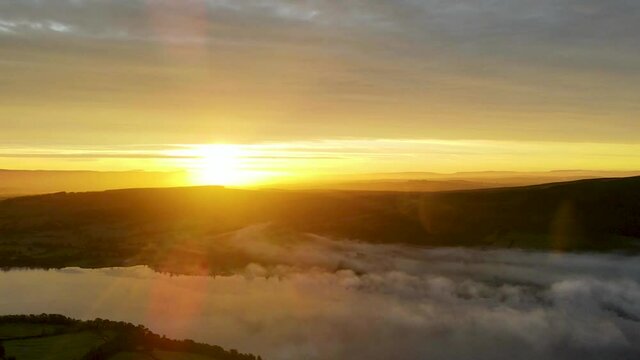 Sunrise over cloud inversion on Ullswater lake, aerial time lapse