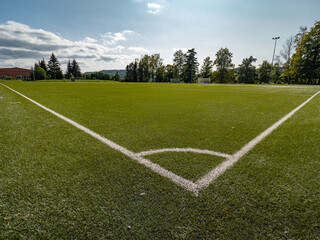 Football or Soccer green grass field, detail of the corner - 387947834