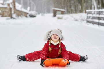 Fototapeta na wymiar Portrait a cute caucasian child on a sleigh