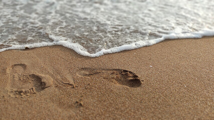 footprints on the sand by the sea