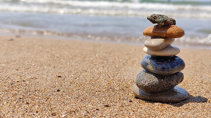 Fototapeta na wymiar concept of balance sea rocks on sand symbolizing zen