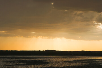 dark summer sunset in a meadow, village sunset