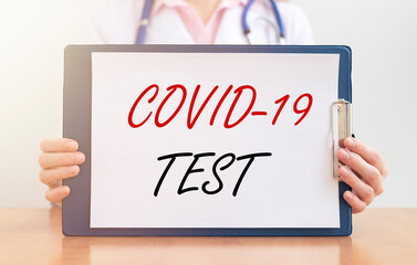 COVID-19 test inscription. Coronavirus concept in doctor hands isolated on white