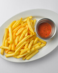 A serving of french fries with tomato sauce. Fast food, junk food concept.