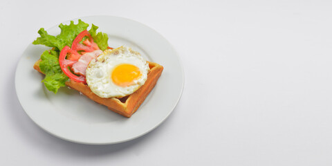 Close up of rustic savory bacon and egg waffle. Traditional breakfast idea. Egg toast for breakfast.