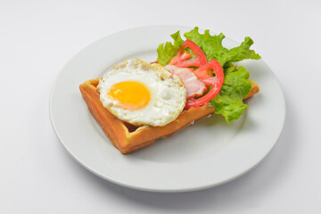 Close up of rustic savory bacon and egg waffle. Traditional breakfast idea. Egg toast for breakfast.