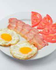 Close up of rustic savory bacon and eggs. Traditional breakfast idea. Egg toast for breakfast.