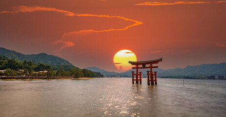 Spectacular composition of Miyajima Torii and sun - obrazy, fototapety, plakaty