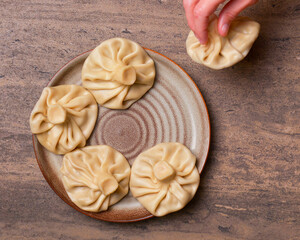 Traditional Georgian khinkali, selective focus, top view. Flat lay of Georgian cuisine. Copy space banner.