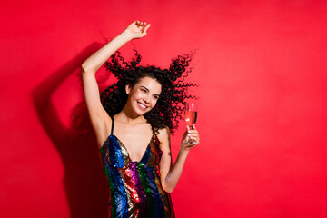 Portrait of charming glad cheerful wavy-haired girl drinking wine having fun rest chill isolated on bright red color background