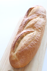 French bread, loaf on wooden board