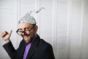 Bearded funny man in a cap of aluminum foil. Concept art phobias.Conspiracy theory. Conspiracy....