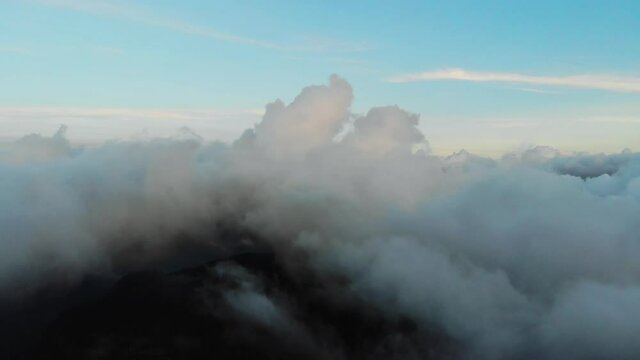 Aerial drone image of the clouds and Mount Baldo during sunset.