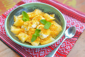 Delicious melon ice cream seved in a bowl over red table cloth. Sweet milk and fruit dessert for hot summer weather.