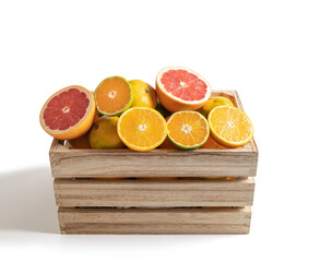 Wooden box with fresh seasonal fruits isolated from the white background