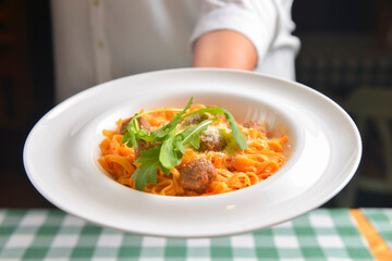 Healthy spaghetti dinner. Traditional Italian pasta with meatballs and cheese. Italian cuisine concept.