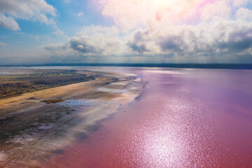 Panoramic view from above at Pink salt lake. Landscape with lake and cloudy sky