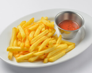 A serving of french fries with tomato sauce. Fast food, junk food concept.
