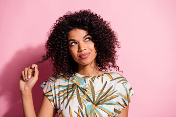 Photo portrait of pouting thoughtful woman touching face cheek with finger isolated on pastel pink colored background