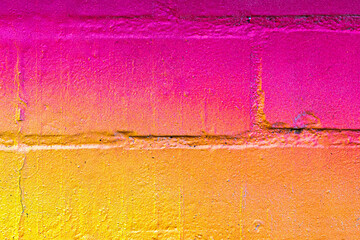 A fragment of colorful graffiti painted on a brick wall. Abstract backdrop for design.