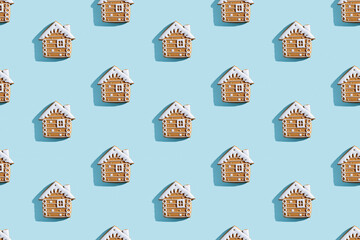 Christmas bakery illustration. Festive food pattern. Homemade cookies. Gingerbread biscuit house figures with white icing isolated on blue pastel.
