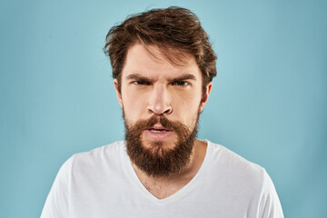 Obraz premium Bearded man emotions facial expression gestures hands close-up blue background