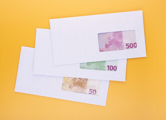 Stack of envelopes with euro bills. Corruption in business, illegal black salary concept