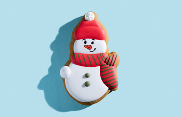 Christmas decorated cookies. Festive pastry. New Year tradition. Winter holiday culinary. Happy gingerbread snowman biscuit figure colorful icing isolated on blue pastel.