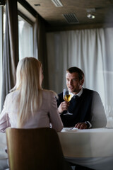 Handsome businessman drinking wine. Businessman enjoying in the restaurant