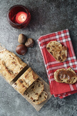 French figs bread on a white and red cloth with chestnuts on the side