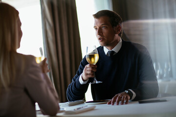 Handsome businessman drinking wine. Businessman enjoying in the restaurant