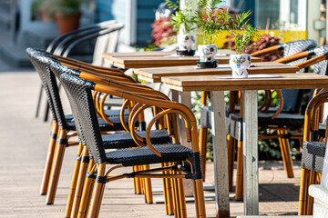 sidewalk open air cafe with empty chairs and  tables