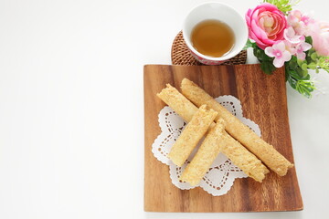 Fototapeta na wymiar Chinese food, asian confectionery egg roll cookie on wooden plate