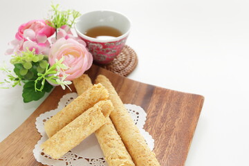 Fototapeta na wymiar Chinese food, asian confectionery egg roll cookie on wooden plate