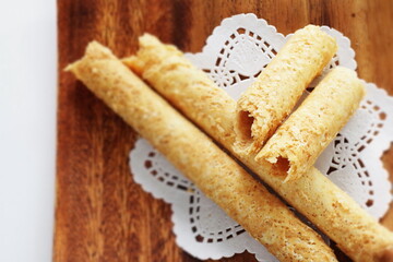 Chinese food, asian confectionery egg roll cookie on wooden plate